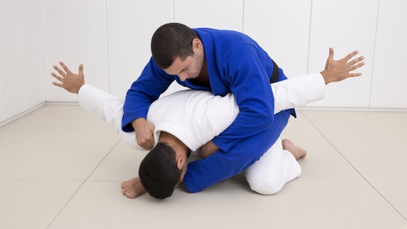 From turtle, the top player traps one of the opponent's arms between their legs in the crucifix.